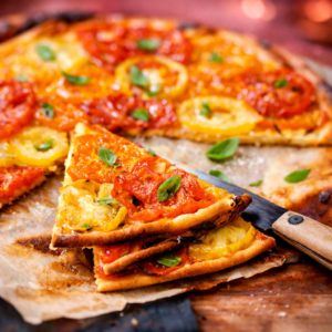 Colorful tomato tart made with a flaky 9-inch crust, a thin mustard layer, assorted tomato slices, and fresh basil, finished with fleur de sel.
