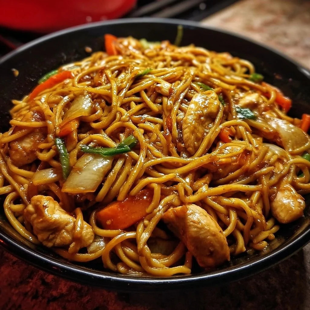 A bowl of Chicken Lo Mein featuring stir-fried noodles, chicken, and vegetables.