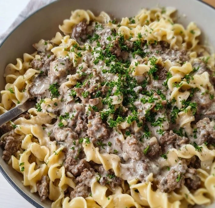 Delicious 30-minute ground beef stroganoff served in a creamy sauce over pasta.
