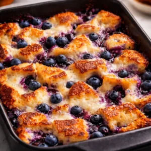 Delicious Blueberry French Toast Casserole baked and served with syrup.