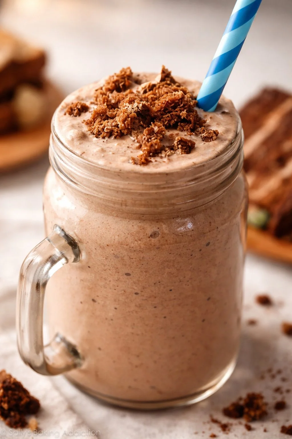 Decadent chocolate cake milkshake topped with whipped cream and chocolate shavings