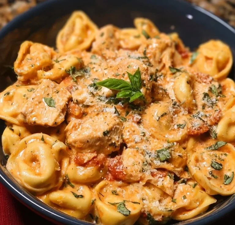 CrockPot Chicken Tortellini in a bowl, garnished with herbs.
