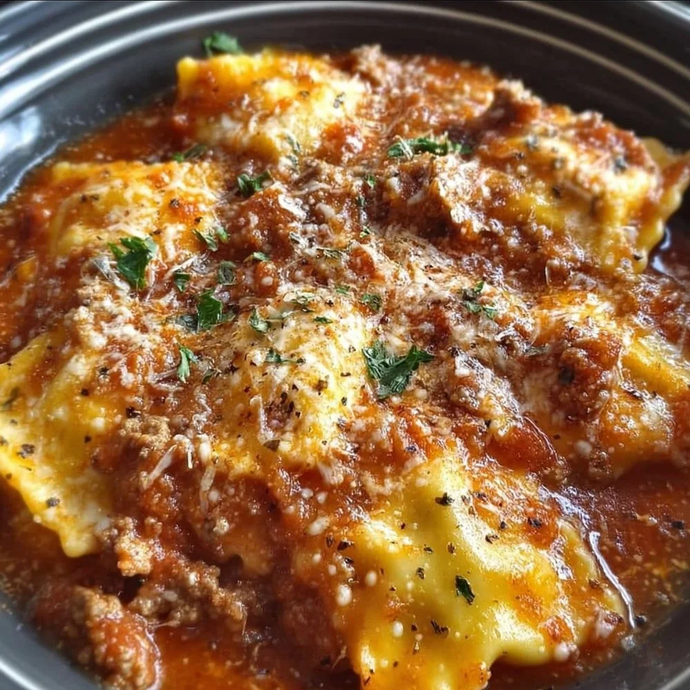 Crockpot Ravioli Lasagna served in a dish, showcasing layers of pasta and cheese.