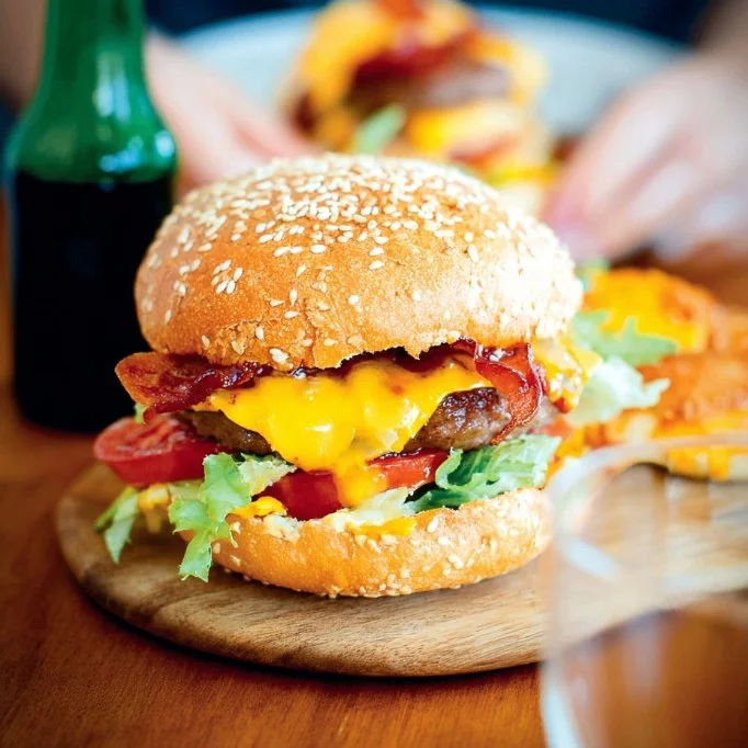 Delicious Hamburger Classic with cheese served on a bun with fresh toppings