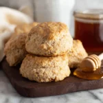 Freshly baked homemade honey whole wheat biscuits on a cooling rack