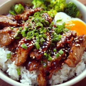 Delicious Honey Garlic Pork Rice Bowl garnished with fresh vegetables