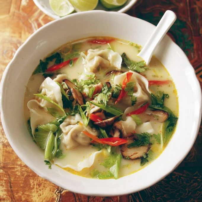 Bowl of Thai Dumpling Soup with colorful herbs and dumplings