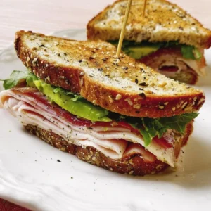 Turkey-Avocado Sandwiches with fresh ingredients on a cutting board