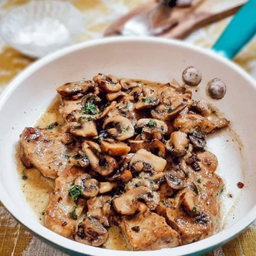 Delicious veal sauté with mushrooms served on a plate.