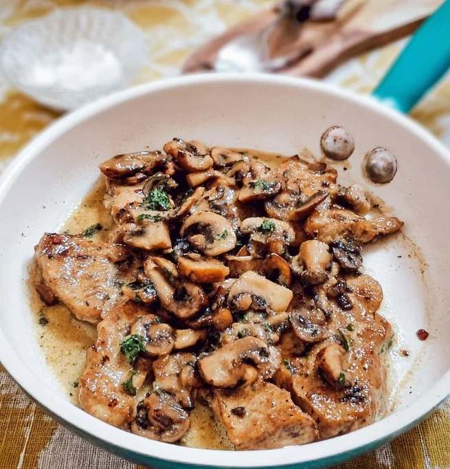 Home Delicious veal sauté with mushrooms served on a plate.