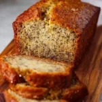Moist banana bread loaf freshly baked and sliced, perfect for breakfast or snacks.