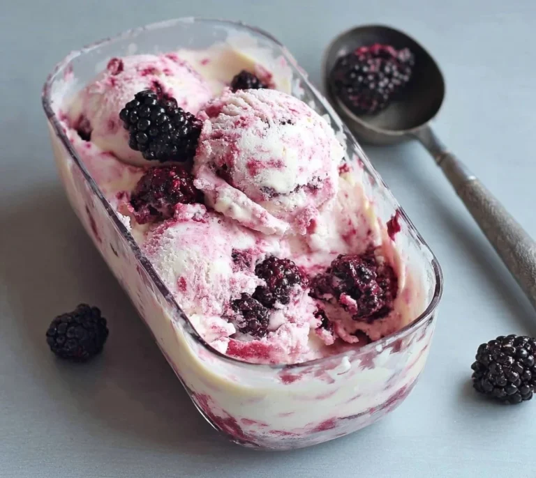 Homemade blackberries and cream ice cream in a bowl with fresh berries on top