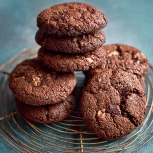 Delicious chocolate hazelnut cookies on a plate with a glass of milk.
