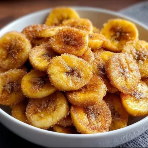 Cinnamon-sugar air fryer banana chips in a bowl, perfect healthy snack.
