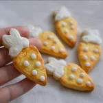 Easter Carrot Shortbread Cookies arranged on a festive plate.