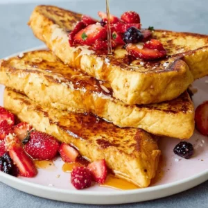 Plate of easy French toast topped with syrup and berries