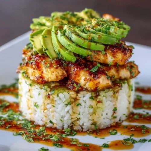 Gluten-free honey lime chicken and avocado rice stack dish.