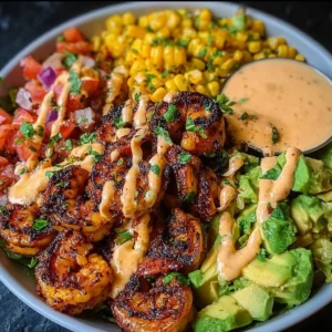 Grilled shrimp bowl featuring avocado, corn salsa, and creamy garlic sauce