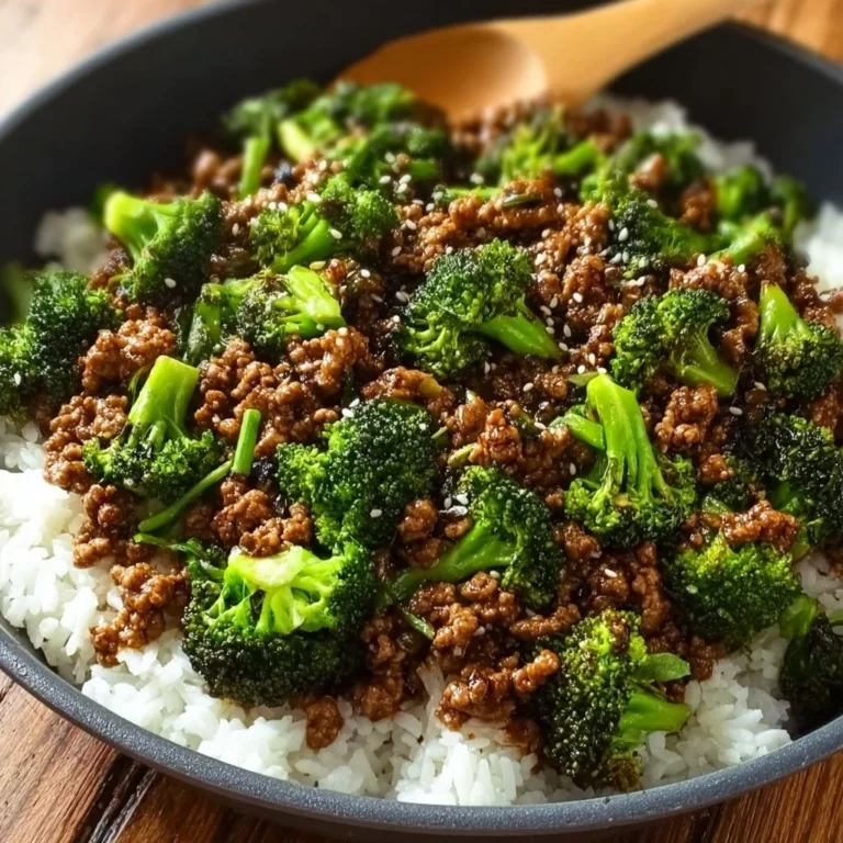 Plate of ground beef and broccoli served over rice with fresh vegetables