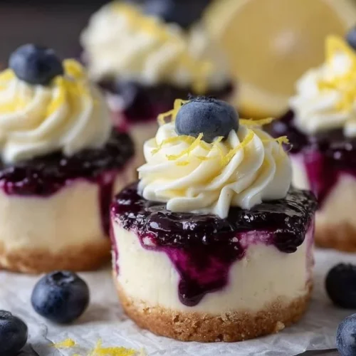 Healthy mini lemon blueberry cheesecakes topped with fresh blueberries