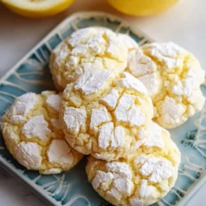 Freshly baked Lemon Crinkle Cookies with a crinkly surface and yellow hue