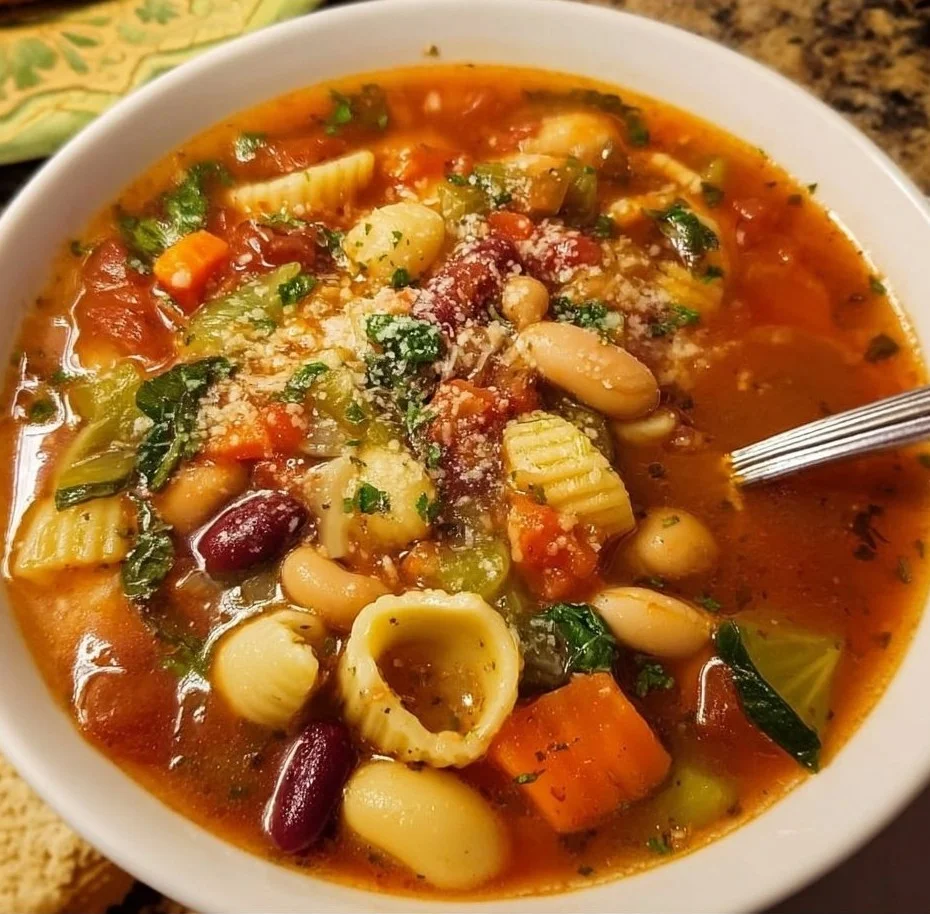 A bowl of Olive Garden Minestrone Soup filled with vegetables and beans