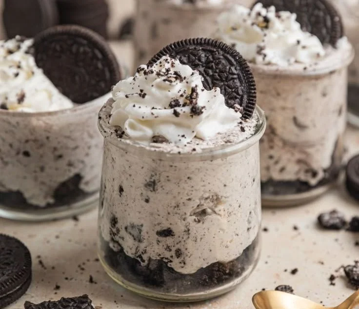 Oreo no-bake cheesecake cups topped with cookie crumbles