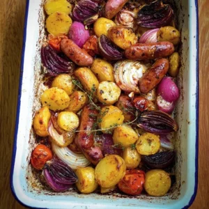 Pink Potato and Sausage Tray Bake Pink potato and sausage tray bake served with fresh herbs