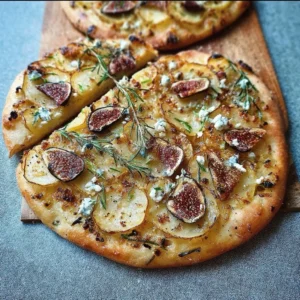 Delicious Potato, Gorgonzola, Rosemary, and Fig Pizzas on a wooden serving board.