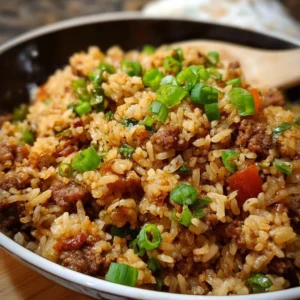A plate of Southern Style Dirty Rice garnished with green onions and spices
