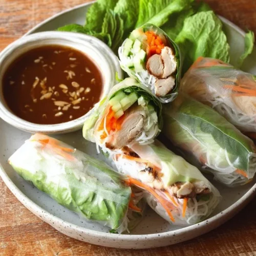 Vietnamese summer rolls with chicken, fresh ingredients, and vibrant colors.