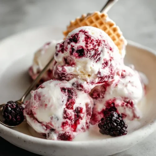 Delicious Blackberry Cheesecake Ice Cream topped with fresh blackberries
