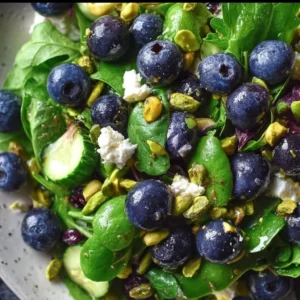 Blueberry Pistachio Spring Salad Blueberry Pistachio Spring Salad garnished with fresh blueberries and nuts