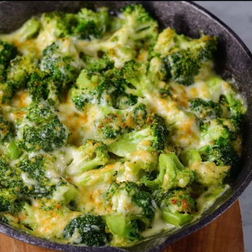 Cheesy Broccoli A delicious serving of cheesy broccoli topped with melted cheese and seasonings.