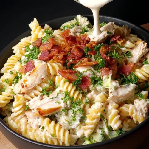 Bowl of Chicken Bacon Ranch Pasta Salad with bacon, chicken, and ranch dressing.