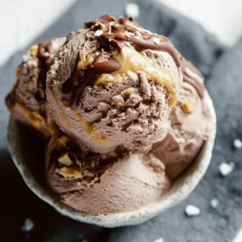 A delicious bowl of Chocolate Peanut Butter Ripple Ice Cream with swirls of chocolate and peanut butter.