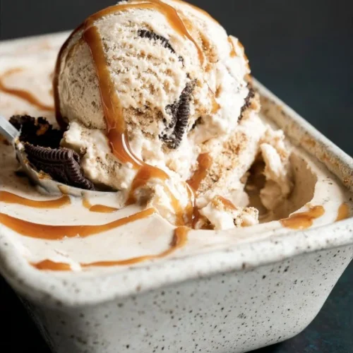 Delicious Coffee Caramel Cookie Ice Cream topped with caramel drizzle and cookie pieces