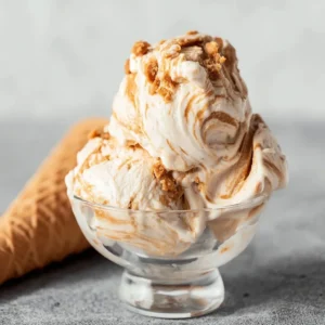 Delicious cookie butter swirl ice cream in a bowl, topped with cookie crumbs.