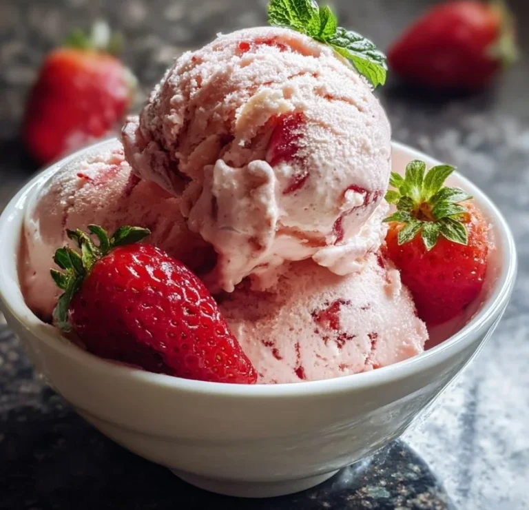 Delicious creamy strawberry ice cream in a bowl with fresh strawberries