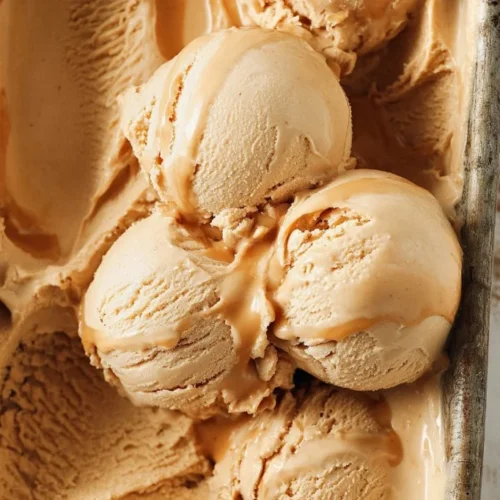 Delicious bowl of Dulce de Leche ice cream topped with caramel drizzle
