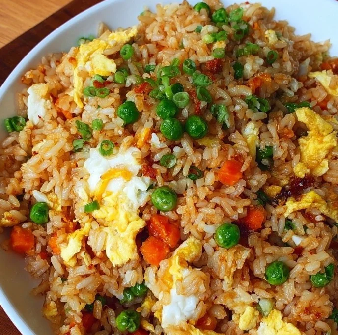 Home A bowl of easy fried rice with colorful vegetables and chopsticks