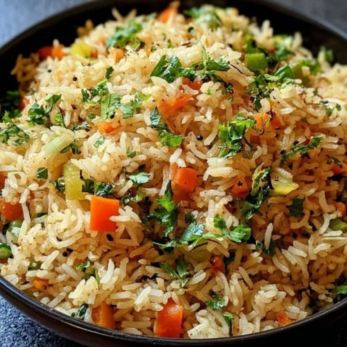 Plate of herbed vegetable rice garnished with fresh herbs and colorful vegetables.