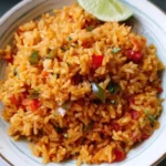 Bowl of easy Mexican rice served with fresh herbs and spices