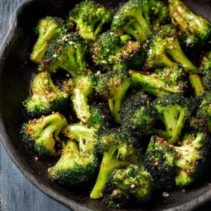 Easy Oven Roasted Broccoli Oven roasted broccoli served on a plate, crispy and golden brown