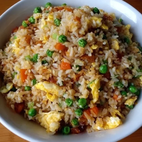 Delicious homemade fried rice served with vegetables and herbs.