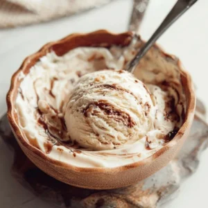 Delicious fudge ice cream with a fudge batter swirl in a dessert bowl
