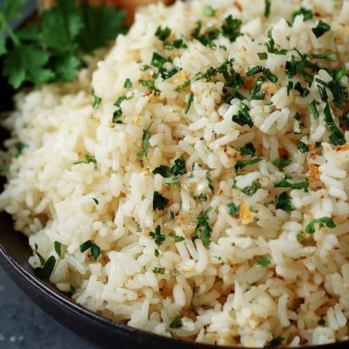 Delicious Garlic Butter Rice served in a bowl with fresh herbs