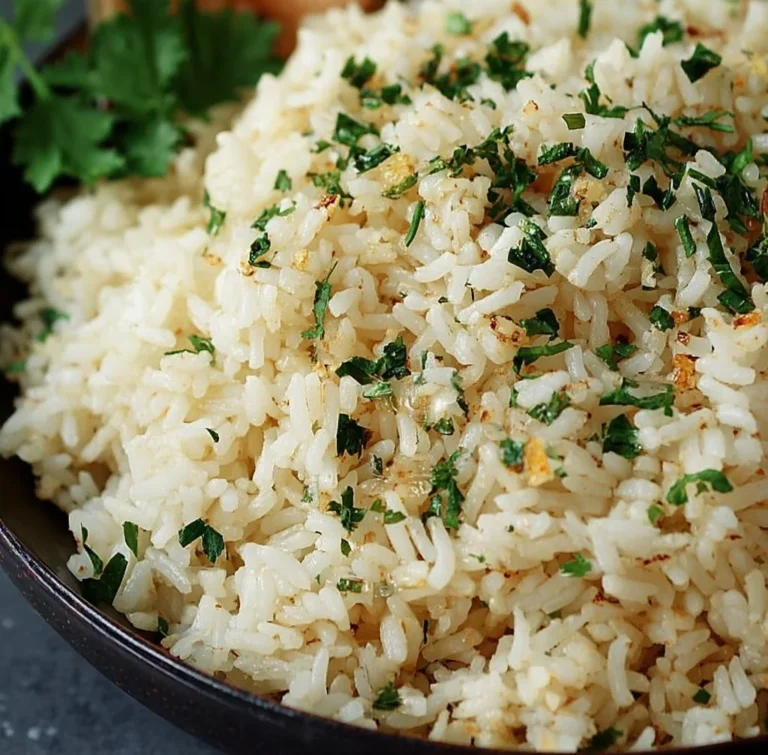 Delicious Garlic Butter Rice served in a bowl with fresh herbs