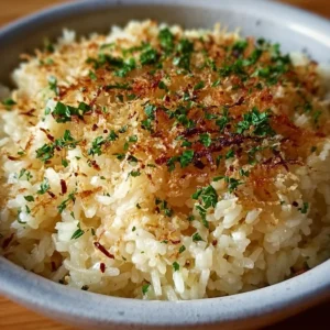 Creamy Garlic Parmesan Rice dish served in a bowl with herbs and cheese