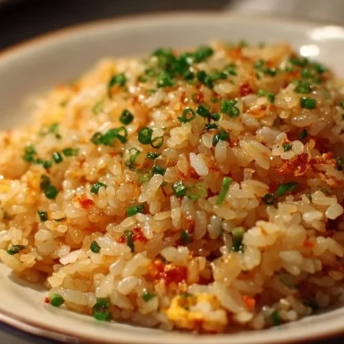 Japanese Garlic Fried Rice Bowl of delicious Japanese garlic fried rice garnished with green onions